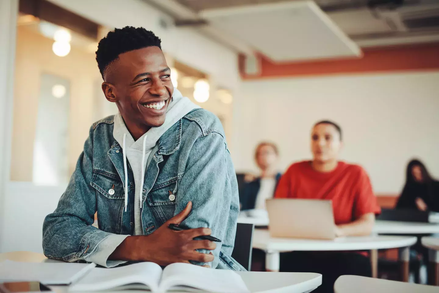 student smiling at desk student smiling at desk