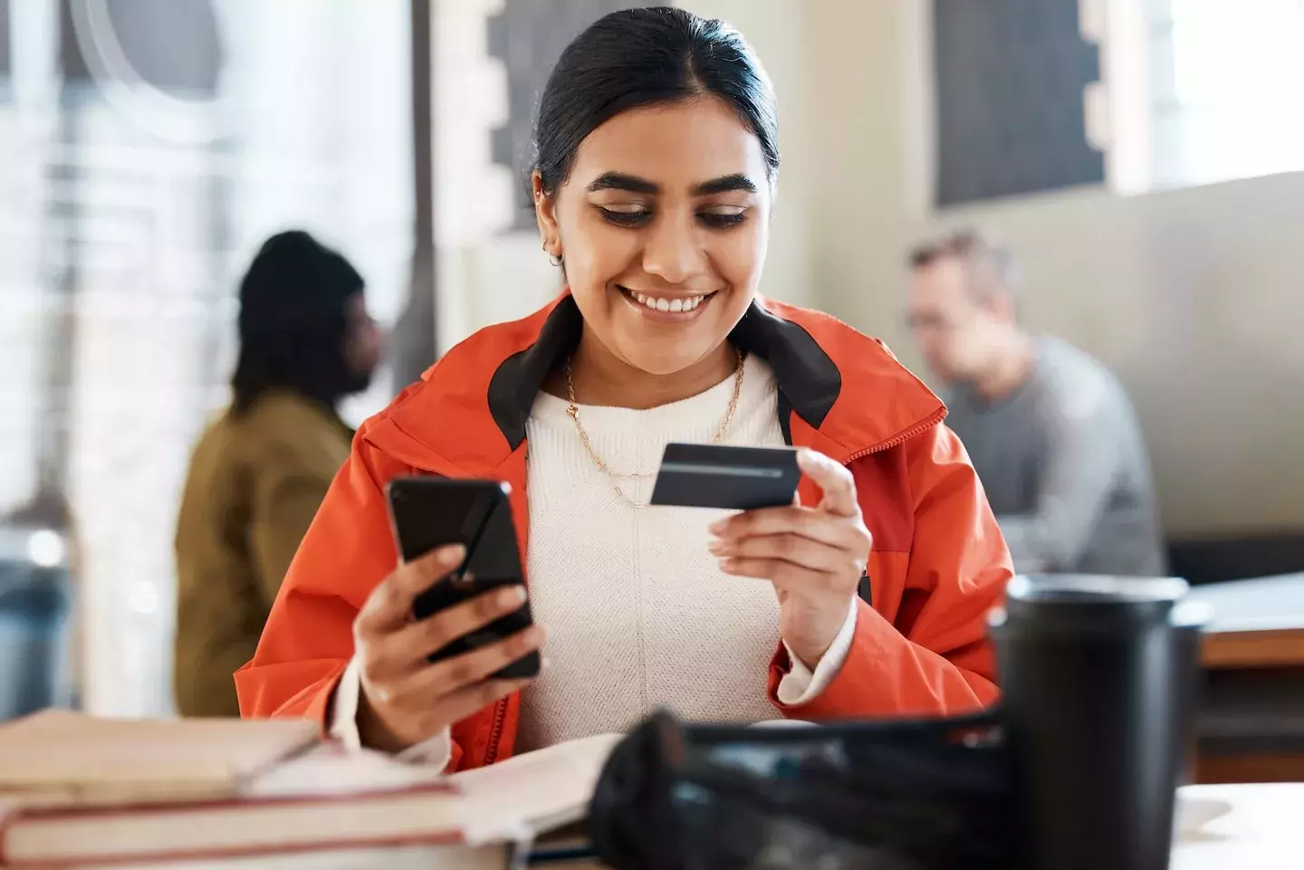 person making a purchase on phone with credit card