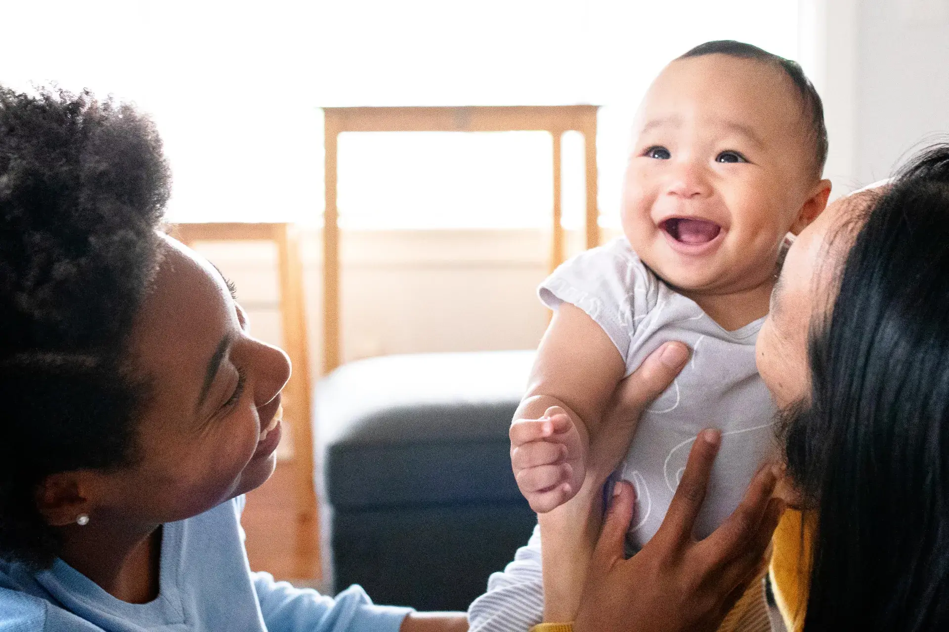 Couple holding smiling baby
