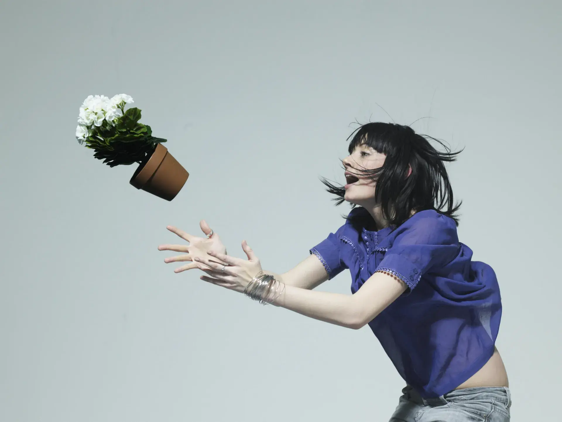 Woman catching a flower pot
