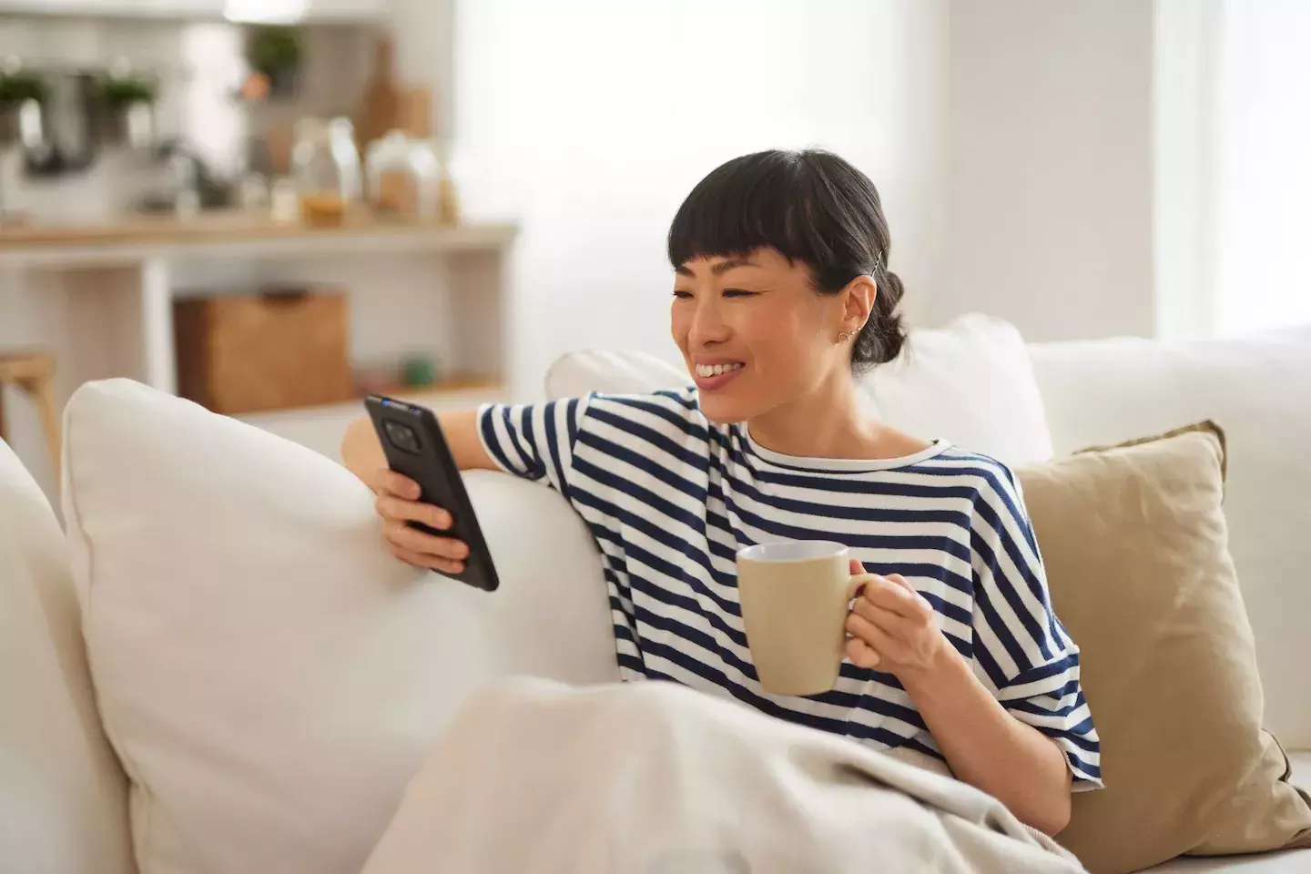 person sitting on couch looking at phone