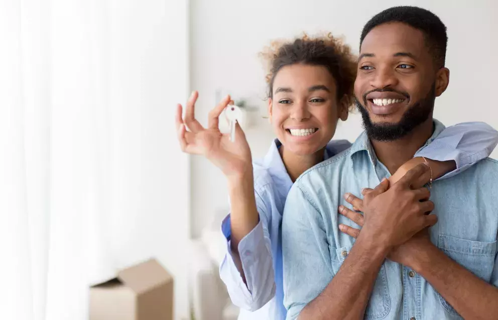 New homeowners holding keys.