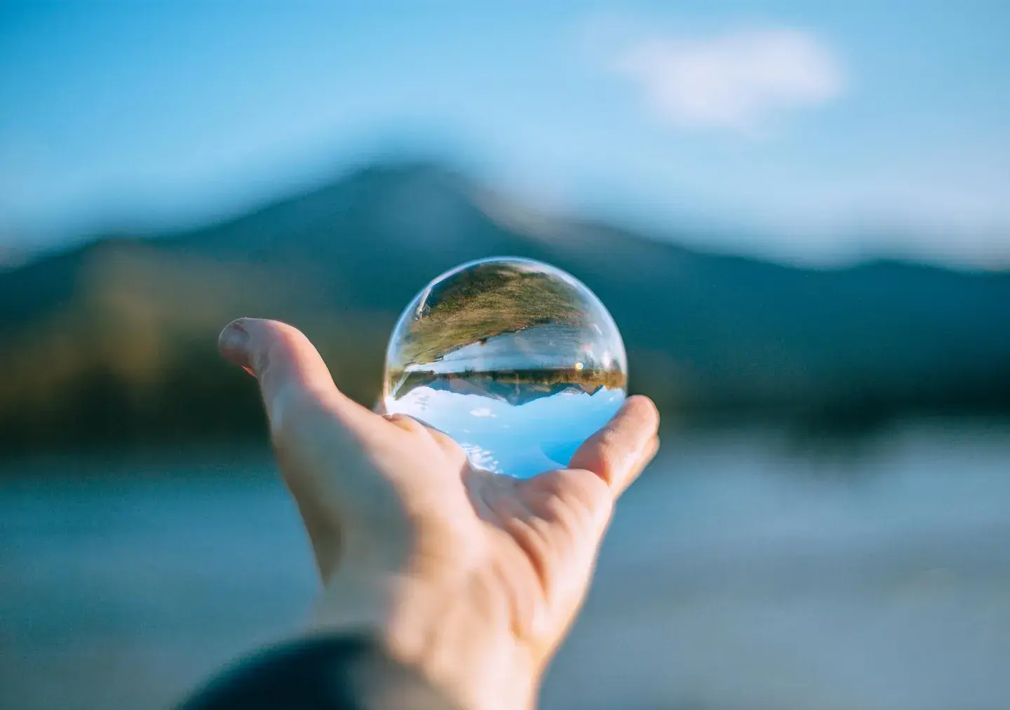 Person holding lens ball